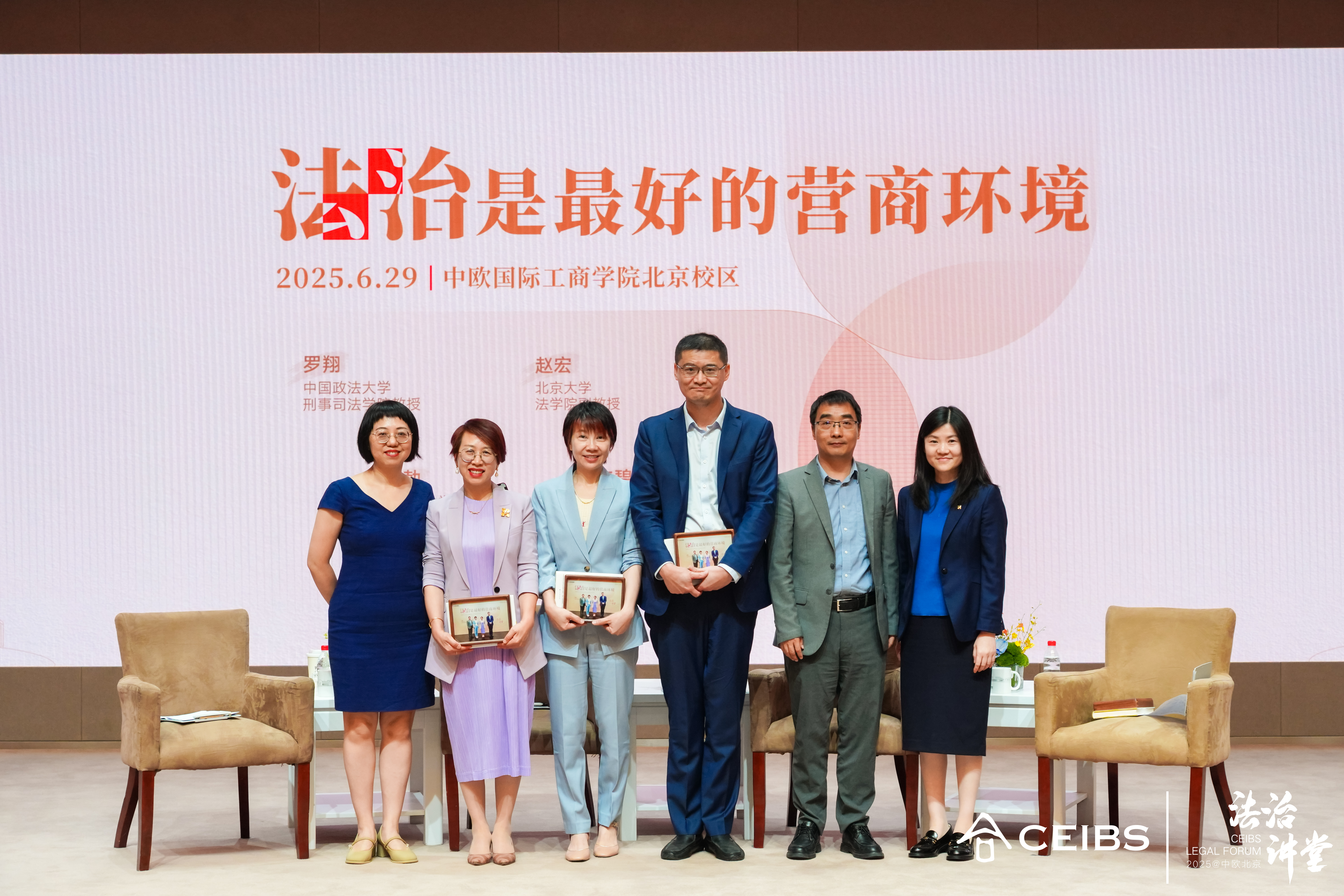 北京校区活动部负责人谈磊向四位教授赠送吴敬琏教授签名书籍和活动照片作为纪念